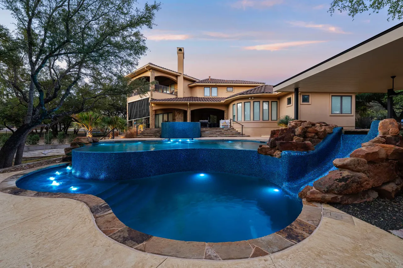 Boulder Slide — Family freeform pool in Tarrytown, TX by GB IV Designs
