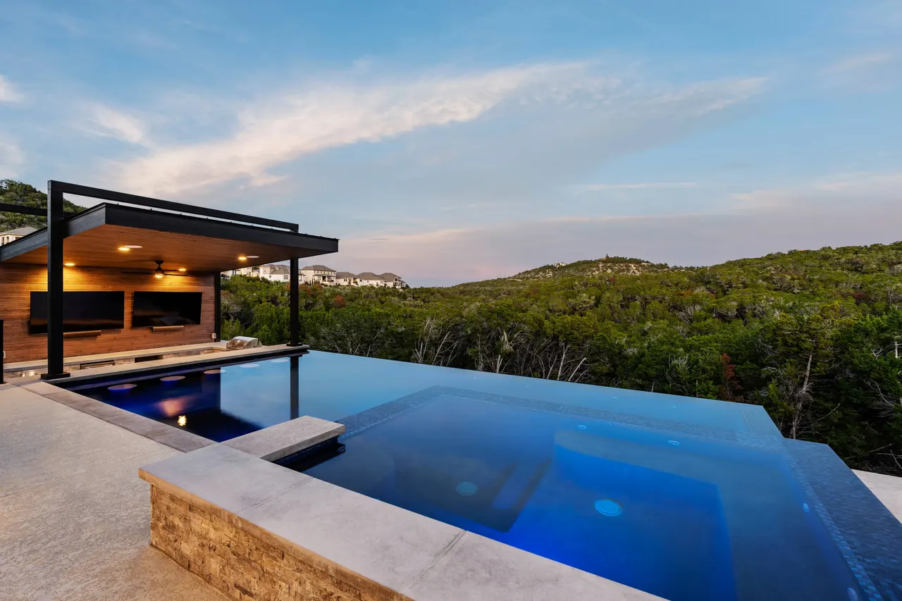 Vanishing-edge pool and cantilevered cabana overlooking a Hill Country canyon