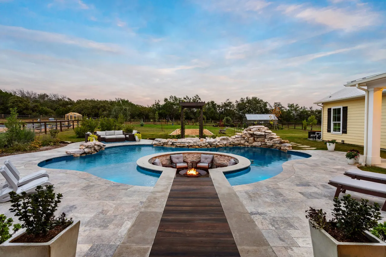 Farmhouse Lagoon — Freeform pool with sunken lounge in Travis County, TX by GB IV Designs (photo 7)
