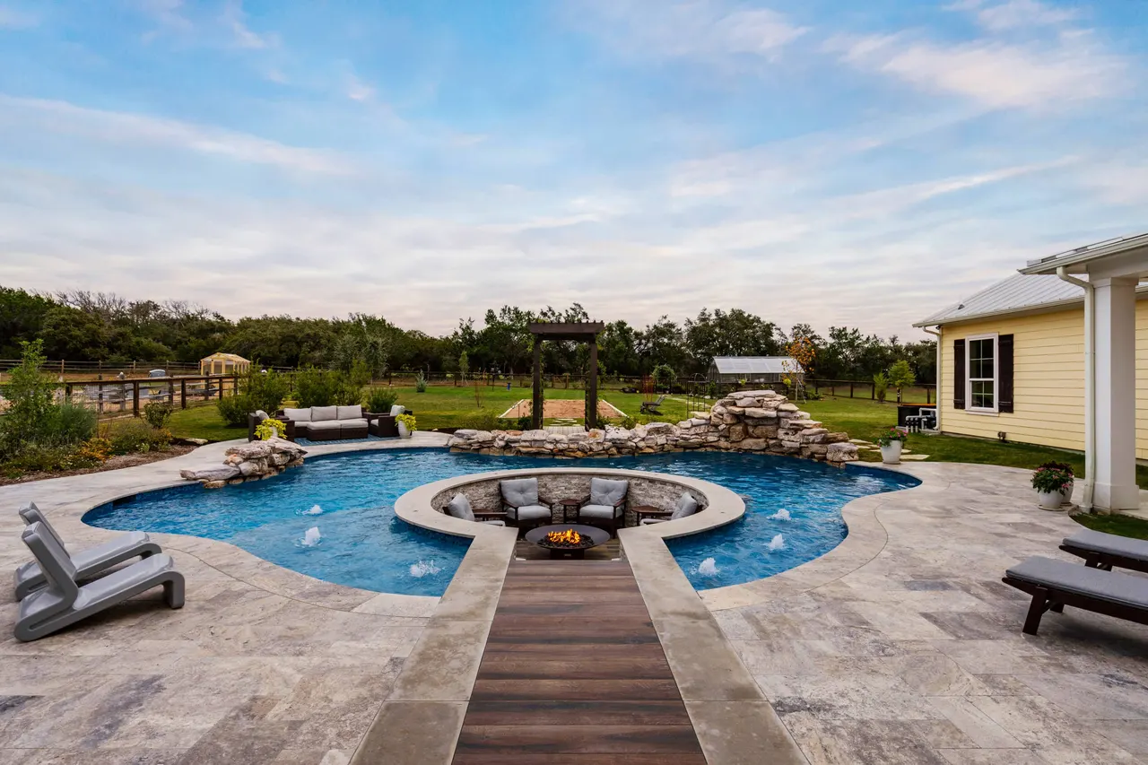 Farmhouse Lagoon — Freeform pool with sunken lounge in Travis County, TX by GB IV Designs (photo 14)